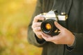 Hipster female photographer shooting outdoors Royalty Free Stock Photo