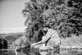 hipster fishing with spoon-bait. mature bearded man with fish on rod. successful fisherman in lake water. fly fish hobby Royalty Free Stock Photo