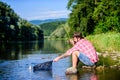 Hipster fishing with spoon-bait. successful fisherman in lake water. fly fish hobby of man. Hipster in checkered shirt Royalty Free Stock Photo