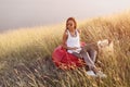 Hipster freelancer woman works outdoors in meadow