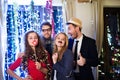 Hipster friends celebrating New Years Eve together, photobooth p Royalty Free Stock Photo