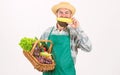 Hipster gardener wear apron carry vegetables. Man bearded presenting vegetables white background isolated. Farmer straw Royalty Free Stock Photo