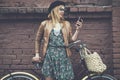 Hipster girl with bike and phone