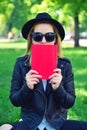 Hipster girl covering her face book Royalty Free Stock Photo