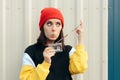 Hipster Girl Damaging a Retro Audio Tape Cassette Royalty Free Stock Photo