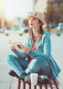 Hipster girl in hat and glasses with book Royalty Free Stock Photo