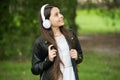 Hipster girl listening music modern headphones nature background, mood and emotions concept