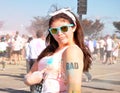 Hipster girl pointing to rad tattoo after marathon race