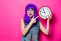 Hipster girl with purple hair and big clock Royalty Free Stock Photo