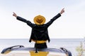 Hipster Girl Sitting on Yellow Car Roof Back View