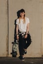 Hipster girl with skate board Royalty Free Stock Photo