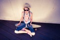 Hipster Girl Skateboarder listening to the music Royalty Free Stock Photo