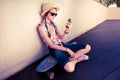 Hipster Girl Skateboarder listening to the music Royalty Free Stock Photo