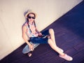 Hipster Girl Skateboarder listening to the music Royalty Free Stock Photo