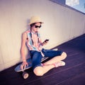 Hipster Girl Skateboarder listening to the music Royalty Free Stock Photo