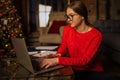 Hipster girl in stylish glasses professional fashion magazine editor checking e-mail on laptop computer Royalty Free Stock Photo