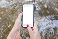 Hipster girl texting message on smartphone mobile with blank screen in forest or mountain stream