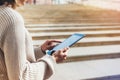 Hipster girl using tablet technology internet, blogger person holding computer on background sun city Royalty Free Stock Photo