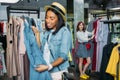 Hipster girls choosing clothes in shopping mall, boutique shopping concept Royalty Free Stock Photo