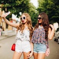 Hipster girls taking self portrait on smart phone. Royalty Free Stock Photo