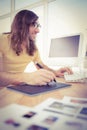 Hipster with graphics tablet typing on keyboard Royalty Free Stock Photo