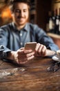 Hipster guy at the restaurant using a mobile phone Royalty Free Stock Photo