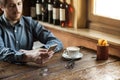 Hipster guy texting with his mobile phone Royalty Free Stock Photo