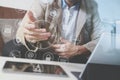 hipster hand using smart phone,digital tablet docking keyboard,coffee cup, payments online business,sitting on sofa in living