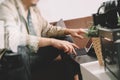 hipster hand using smart phone,digital tablet docking keyboard,coffee cup, payments online business,sitting on sofa in living