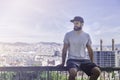 Hipster handsome male model with beard wearing gray blank t-shirt and a black snapback cap with space for your logo or Royalty Free Stock Photo