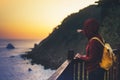 Hipster hiker tourist with backpack looking of amazing seascape sunset on background blue sea, girl enjoying ocean horizon, panora Royalty Free Stock Photo