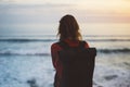 Hipster hiker tourist with backpack looking of amazing seascape sunset on background blue sea, photographer enjoying ocean horizon Royalty Free Stock Photo