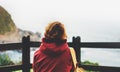 Hipster hiker tourist with backpack looking on seascape sunset, background blue sea and mountain, girl enjoying ocean horizon, pan Royalty Free Stock Photo