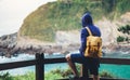 Hipster hiker tourist with backpack looking on seascape sunset, background blue sea and mountain, guy enjoying ocean horizon Royalty Free Stock Photo