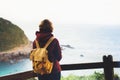 Hipster hiker tourist with backpack looking on seascape sunset Royalty Free Stock Photo