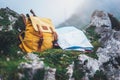 Hipster hiker tourist yellow backpack and map europe on background green grass nature in mountain, blurred panoramic landscape Royalty Free Stock Photo