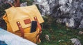 Hipster hiker tourist yellow backpack and mobile phone, map on background green grass nature in mountain, blurred panoramic land Royalty Free Stock Photo