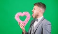 Hipster hold heart symbol love. Bring love to family holiday. Romantic surprise. Man in love strict wear formal suit