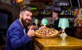 Hipster hungry eat italian pizza. Hipster client sit at bar counter. Man received delicious pizza. Enjoy your meal Royalty Free Stock Photo