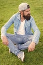 Hipster lifestyle. Cool hipster with beard wear stylish baseball cap. Brutal handsome hipster man resting on summer day