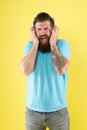 Hipster listen broken headphones music gadget. Hateful song. Music taste. Bearded guy dislike music. Irritating sound Royalty Free Stock Photo