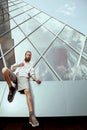 Hipster with long beard and tatoos in front of office building Royalty Free Stock Photo