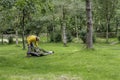 Hipster looking person erecting tent on rural campside in uk.