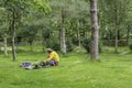 Hipster looking person erecting tent on rural campside in uk.