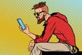 The hipster looks at smartphone