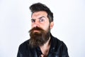 Hipster looks surprised and suspicious while raising his eyebrow. Masculinity concept. Man with beard and mustache on Royalty Free Stock Photo