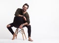 Hipster male posing on chair