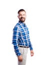 Hipster man in checked blue shirt, studio shot, isolated.