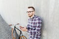 Hipster man in earphones with smartphone and bike Royalty Free Stock Photo