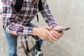 Hipster man in earphones with smartphone and bike Royalty Free Stock Photo